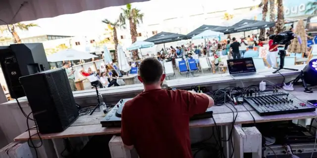 ASTR seen from behind facing the crowd from the booth